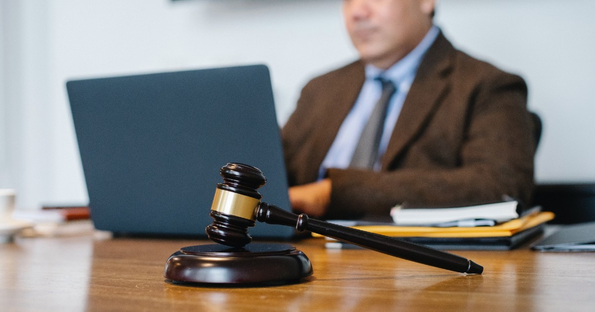 A gavel in front of a computer