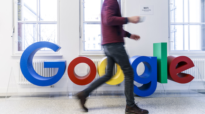 Google sign with worker walking by