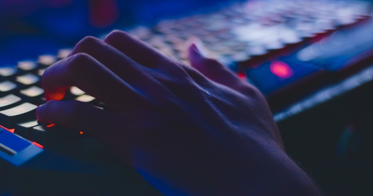 hand on a keyboard in the dark