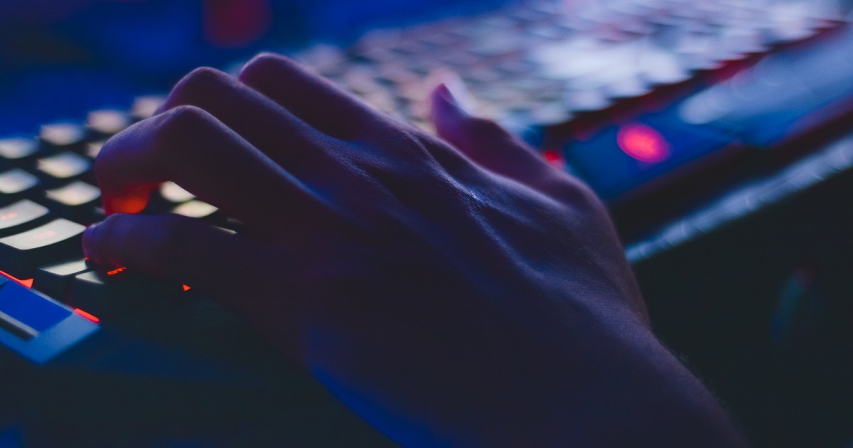 A hacker's hand on a keyboard