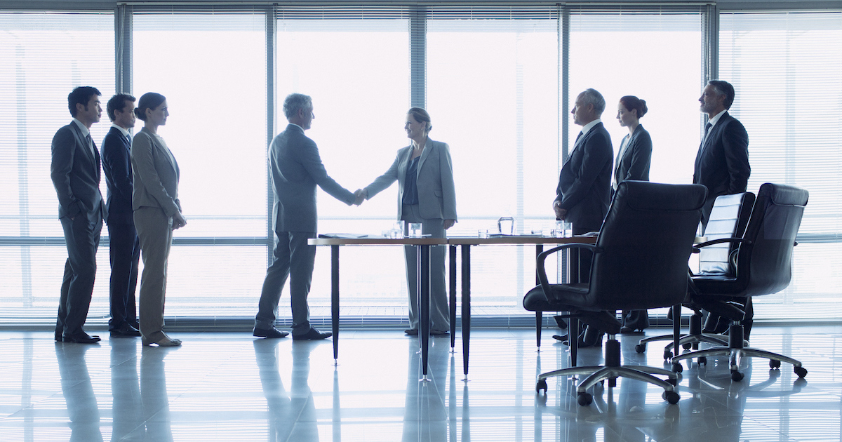 Businesspeople shaking hands at a meeting