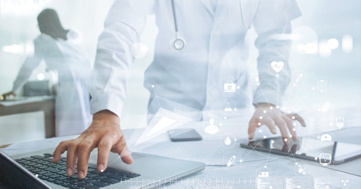 Healthcare professional with tablet and laptop
