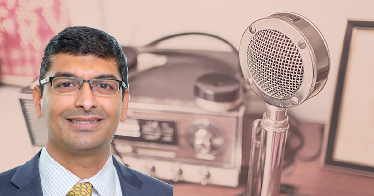 Dr. Maulik Majmudar's headshot on a background with a mic
