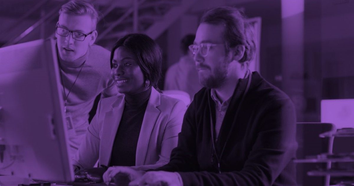 Workers looking at a monitor