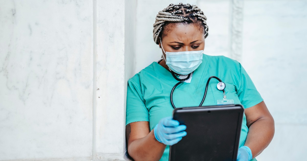 A medical professional holding a tablet