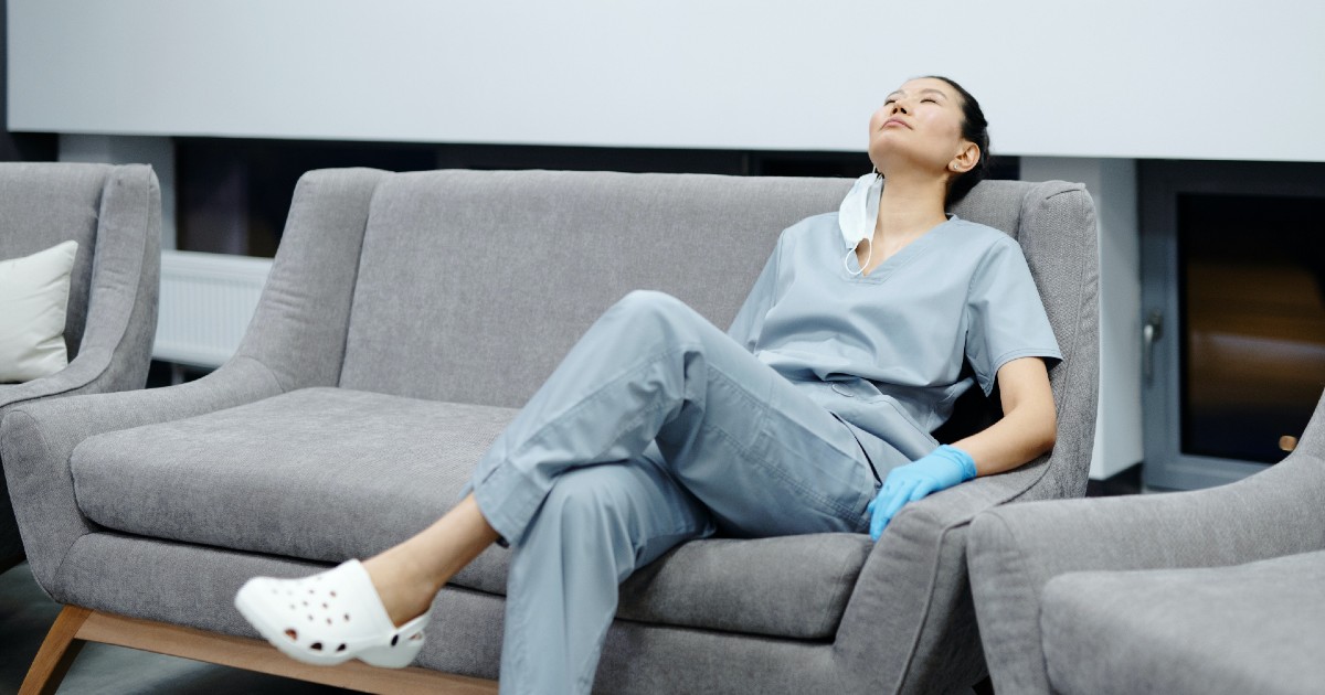 A clinician relaxing on a sofa