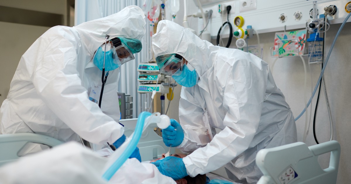 Healthcare workers intubate a patient
