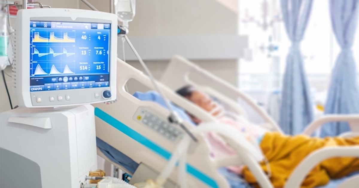 Patient in hospital bed with ventilator