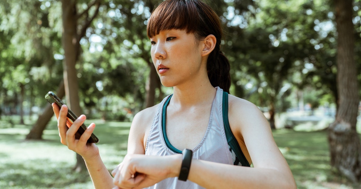 A person checking their vitals on a fitness tracker-paired smartphone