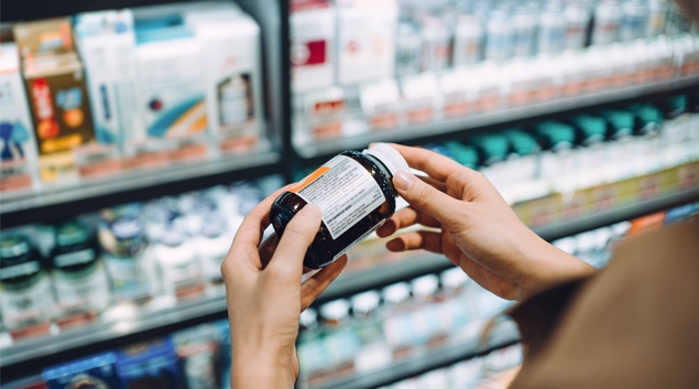 Person looking at pill bottle in Pharmacy
