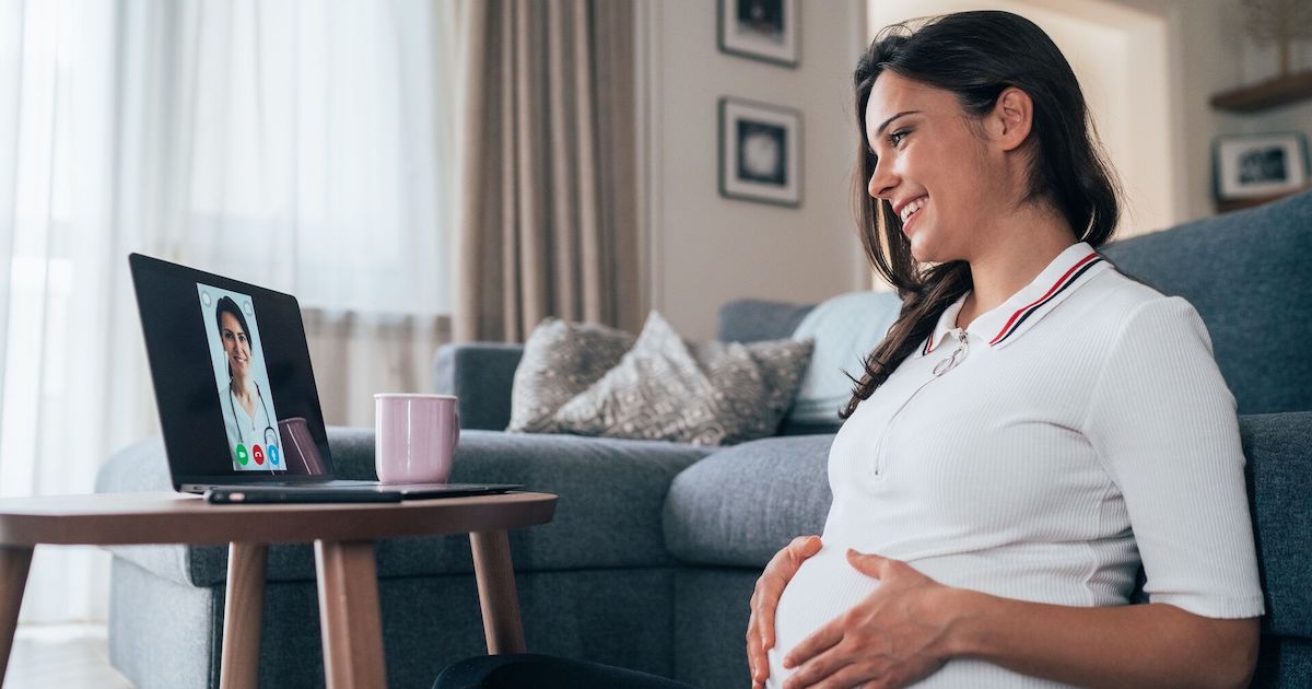 Pregnant person talking to doctor on laptop screen