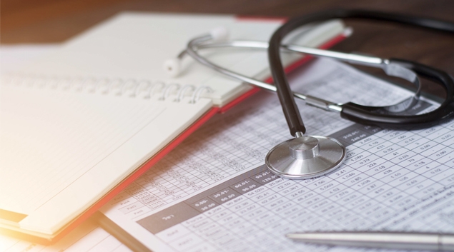 Paper charts and stethoscope