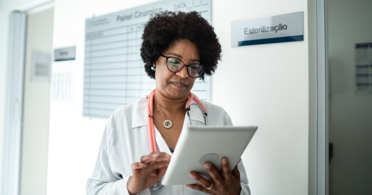 A provider looks at patient forms on a tablet