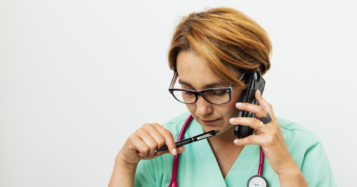 Clinician talking on phone to a patient screening for SDOH