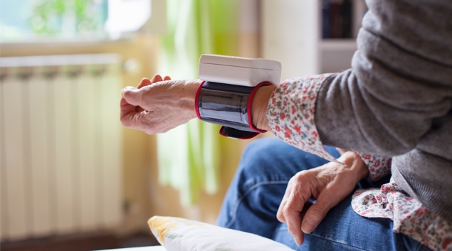 Senior wearing medical monitoring bracelet