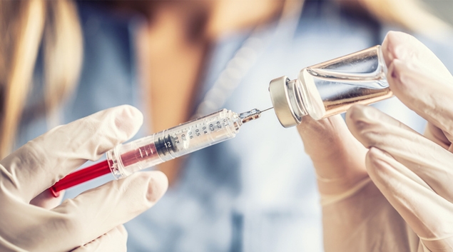 Healthcare worker filling syringe