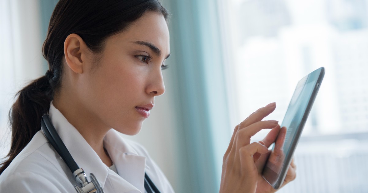 Doctor reviews information on a tablet