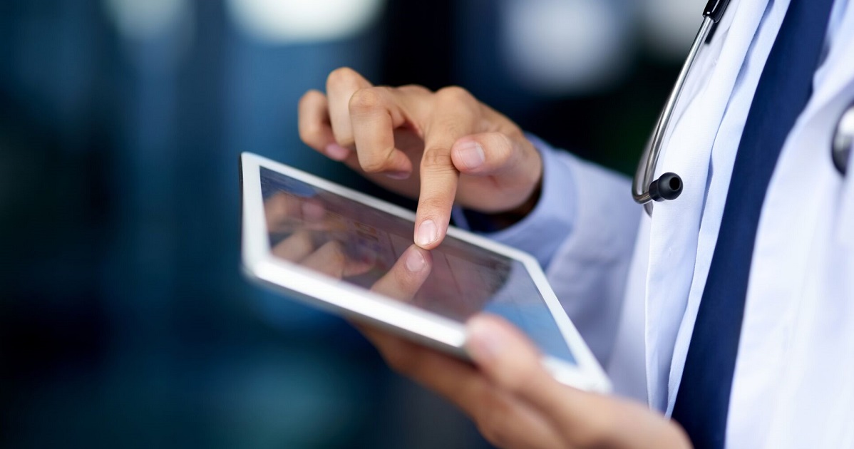 A doctor holding a tablet.