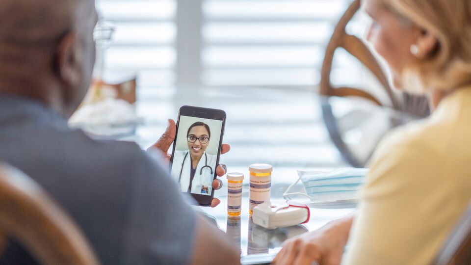 People attending telehealth appointment on smartphone