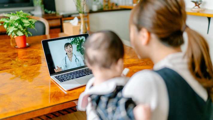 Patient with child attending telehealth appointment