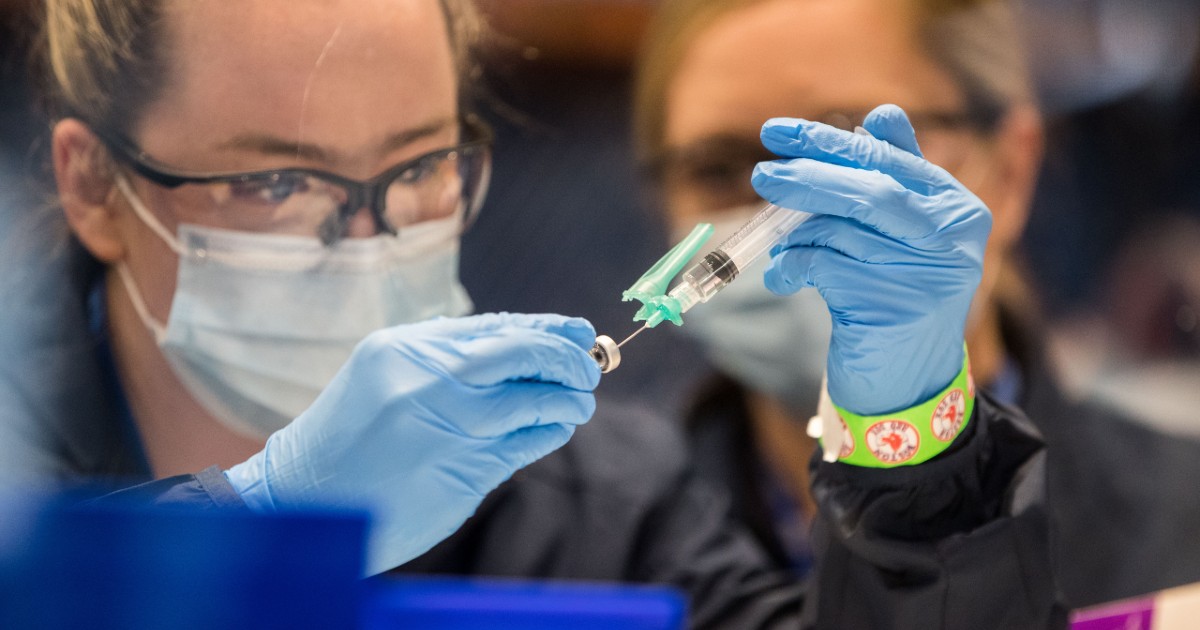 A healthcare worker prepares the COVID-19 vaccine