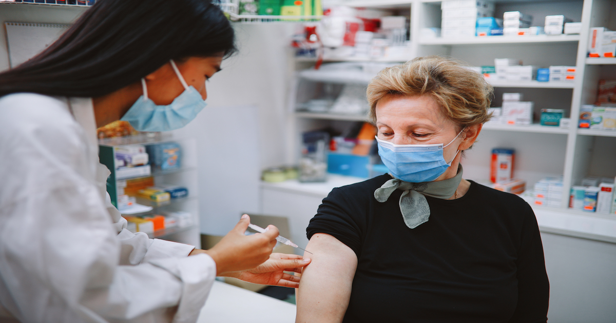 Patient in mask getting vaccine