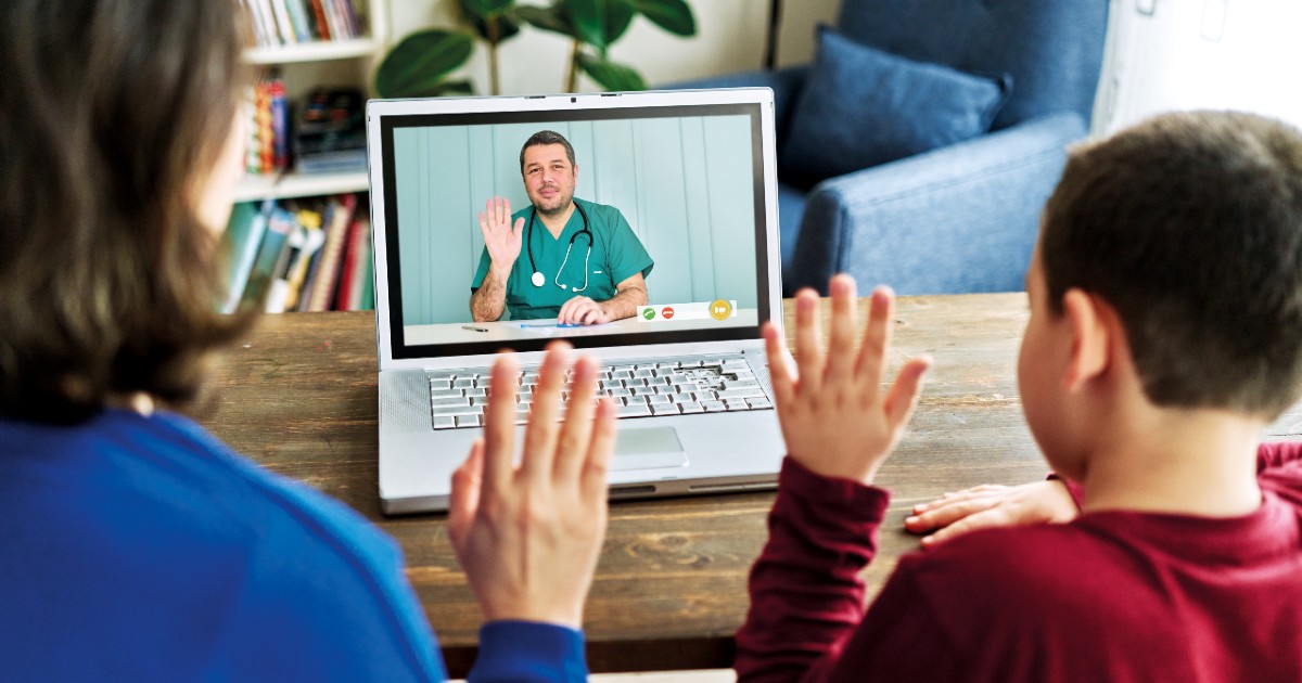 Two patients waving to a clinician on a screen