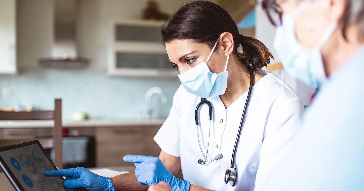 Clinicians consult a tablet