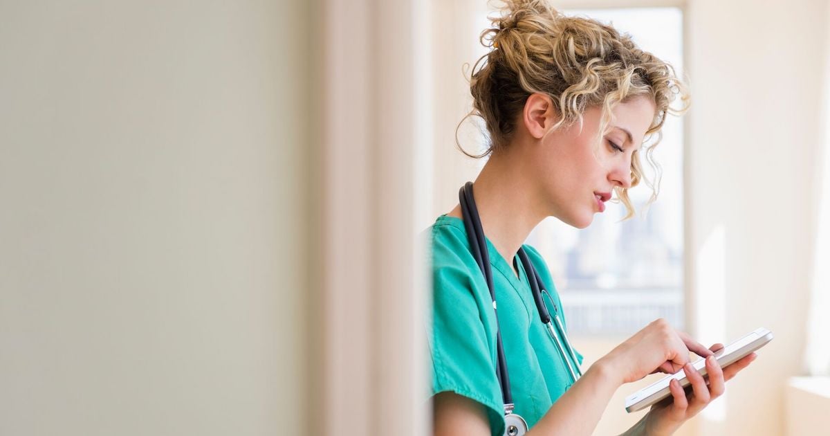 A doctor checking electronic records on a digital tablet