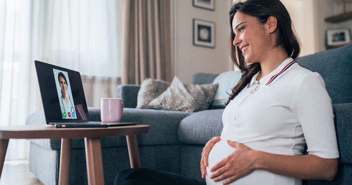 Pregnant person meeting with doctor on laptop