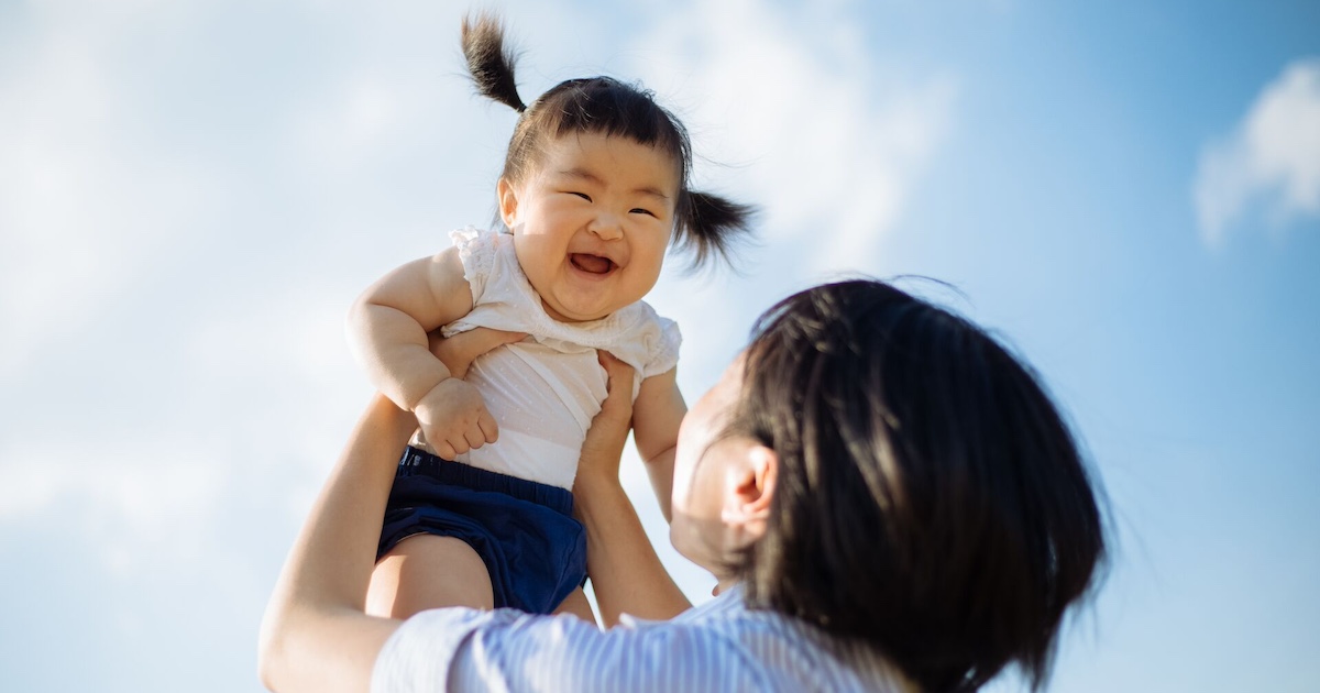 Parent holding child in the air
