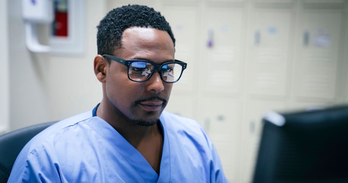 Healthcare worker looking at a computer screen