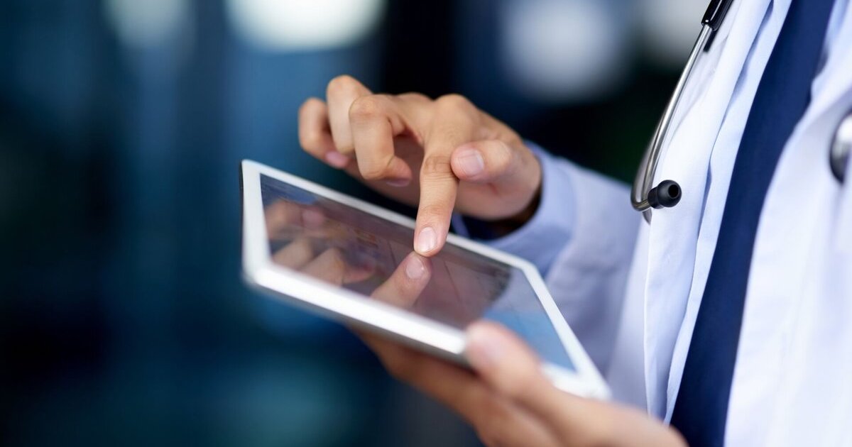 Health professional using a tablet