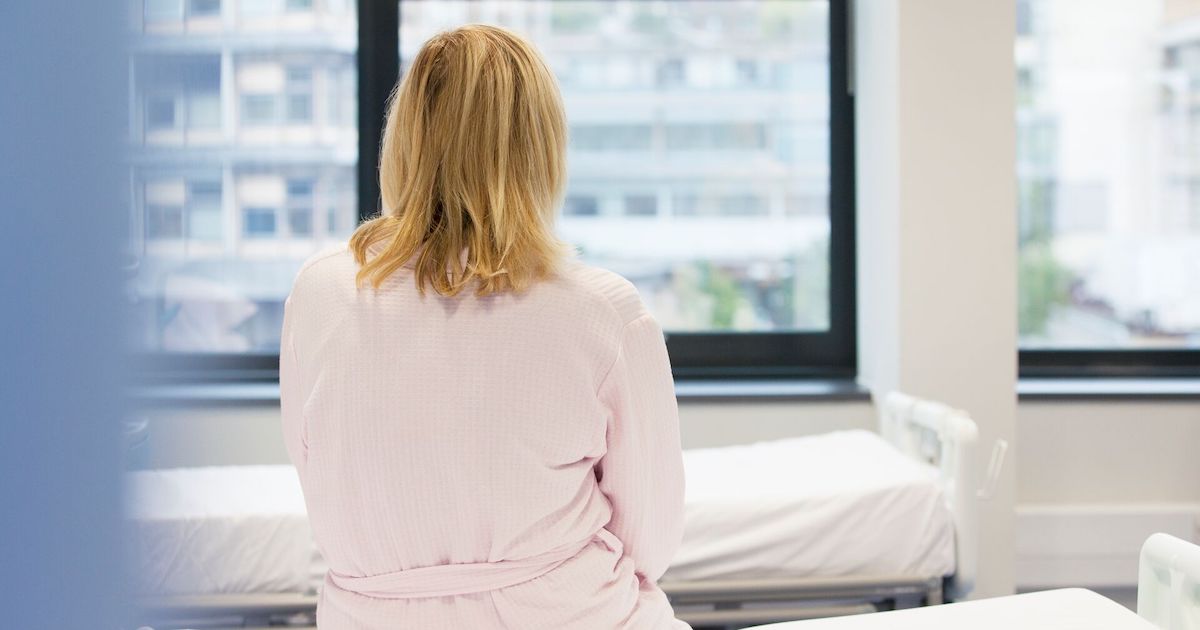 Person sitting on hospital bed