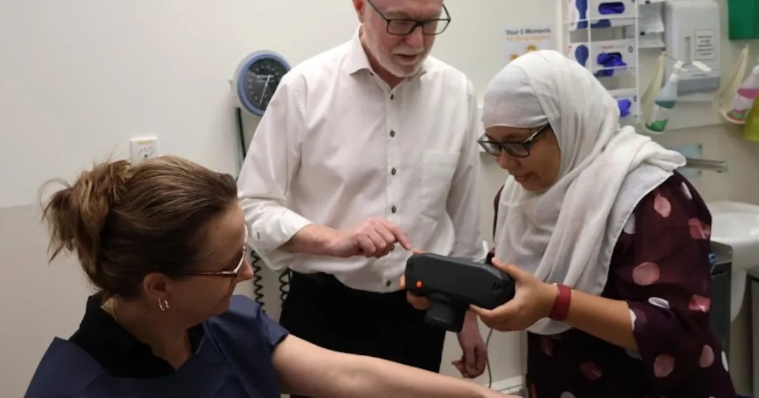 Healthcare workers using a medical scanner with patient