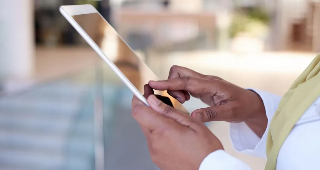 Hands holding a tablet