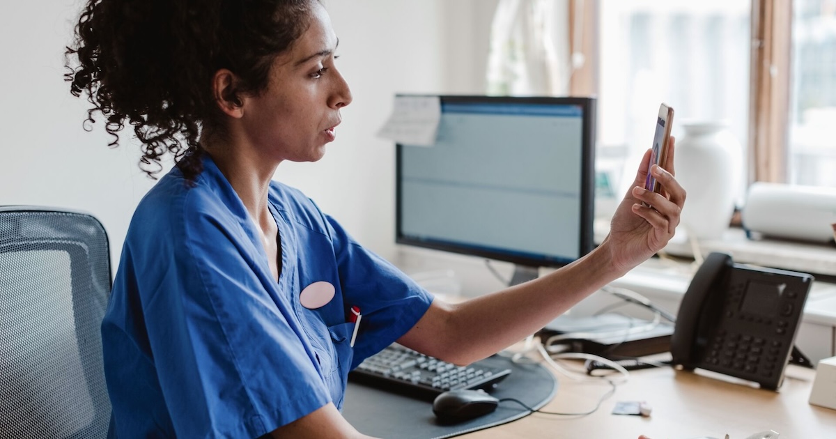 A nurse taking a video call from a smartphone