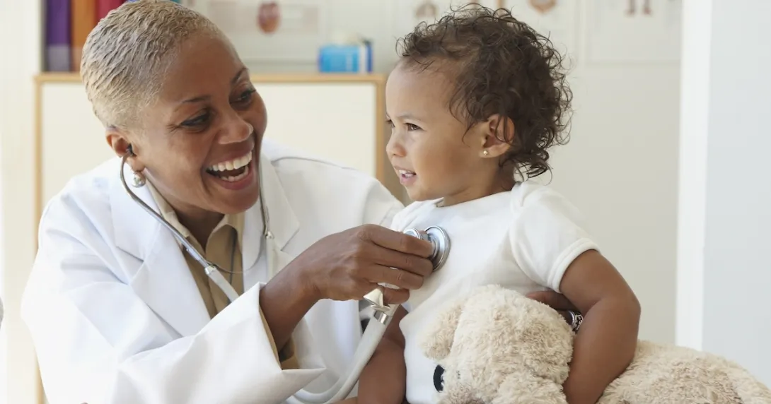 Pediatrician listens to baby's heart with stethoscope