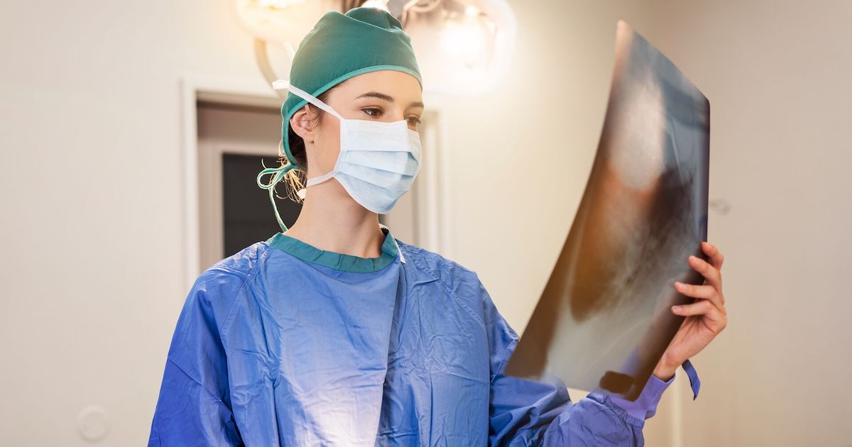 A surgeon examining an X-ray image 