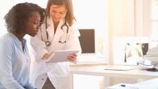 Medical worker showing patient tablet