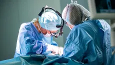 surgeons operating on a patient