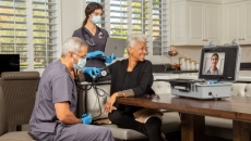 A home health visit with a screen on a table