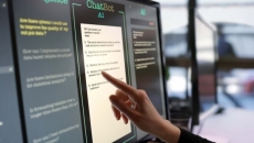 Person touching AI chatbot promot on computer module