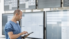 Person in scrubs with tablet