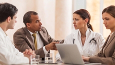 Doctors meeting with business people