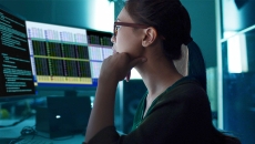 Worker looking at dual monitor