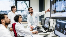 Healthcare workers pointing at a medical image on a display