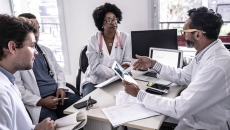 Doctors sitting at a desk and discussing data