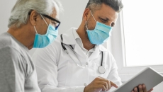 A medical consultation in person with a tablet