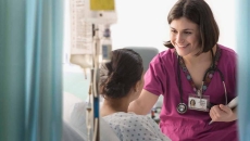 Healthcare worker talking to patient in hospital